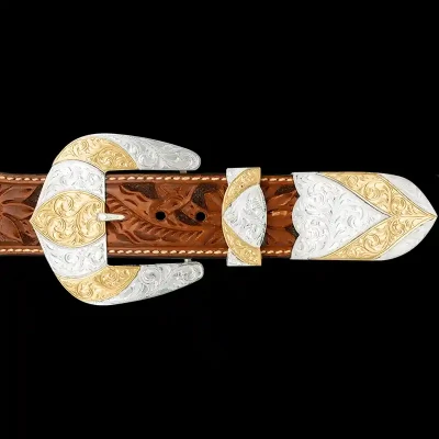 A custom western three piece betl buckle set featuring a silver plated base and golden bronze accents
